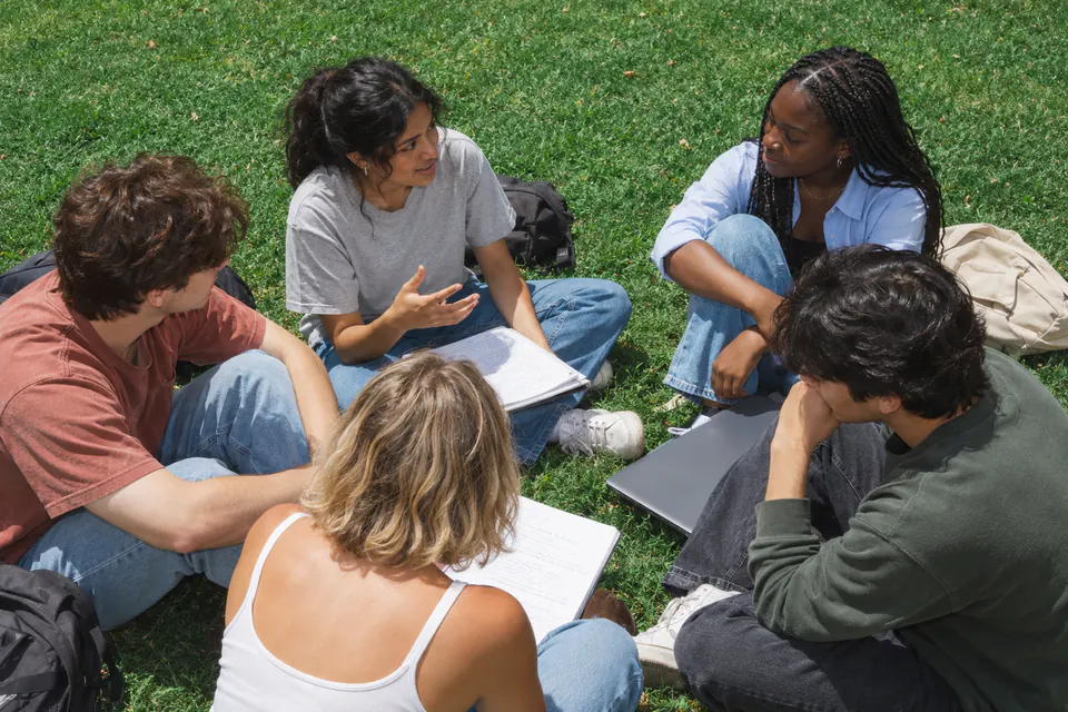 Creators sharing ideas in a circle outdoors