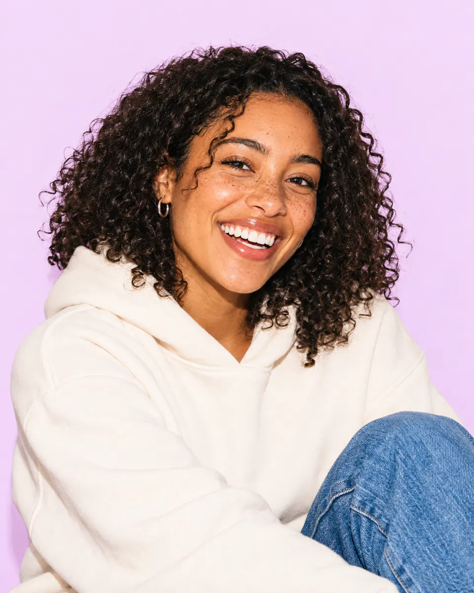 Maya Bennett in a cream hoodie